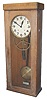 Electric clock in an oak case 35 inches high.