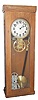Electric clock in an oak case 39-1/2 inches high.