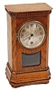 German mini-mini clock. Great little oak case, 8" by 4.5", dentiltype molding around the top, ripple type around the base, beveled moldingjust below the ripple, 4 round wood feet.