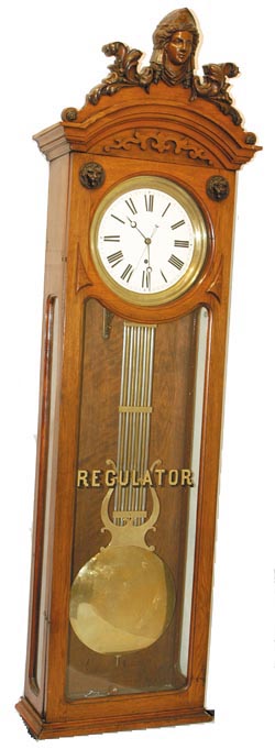 American walnut case with outstanding carved head piece. — Antique Clocks Price Guide