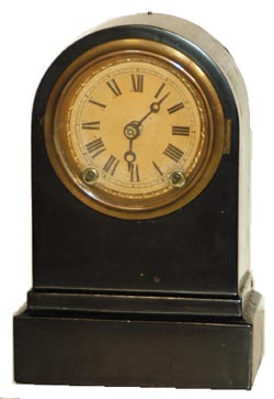 Terry Clock Co. iron cased clock. This model is 8" high, round top, one day, time and strike. — Antique Clocks Price Guide