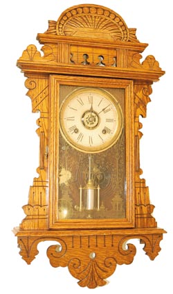 Ansonia Clock Co. oak hanging kitchen, made expressly for the American Wringer Co. The label designates it the "Eclipse" model, 8 day, half hour strike. — Antique Clocks Price Guide