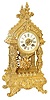 French solid cast brass, open well shelf clock. Cathedral style top, decorative roof, 4 columns, all resting on the footed base.