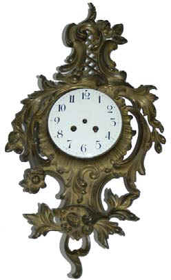 French cartel, ca 1890. Bronze colored metal case is 20 inches high, 11.5 inches wide, and it has been a long time since it was cleaned, if ever. — Antique Clocks Price Guide