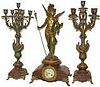French clock-statue, with candelabra sidepieces.