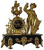 French statue-clock. A busy little clock with ornaments dangling all over the black onyx base, clock tower, and the grape picker.
