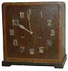 Looks Mission with the brass numerals on wood face, brass hands.