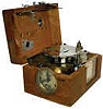 Pigeon Timer, Racing Clock Enclosed in an oak case, leather carrying handle, metal side latch.