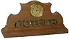 Novelty clock, American one day movement in a solid block of walnut with the word "MOTHER" carved (sawed) out.
