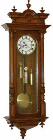 Vienna Regulator, 3 weights, 8 day quarter hour striking movement. The 49 inches walnut case is near mint, has half columns that are carved and turned, 3 good glasses, pendulum, and weights. — Antique Clocks Price Guide