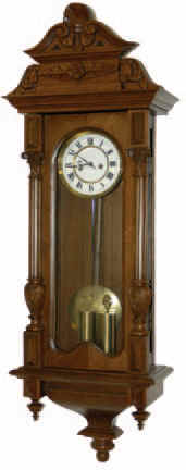 German 2 weight Vienna Regulator in a fairly rare size case, that is 41.75 inches high. The walnut case is excellent, has a carved top and carved sections on both half columns. — Antique Clocks Price Guide