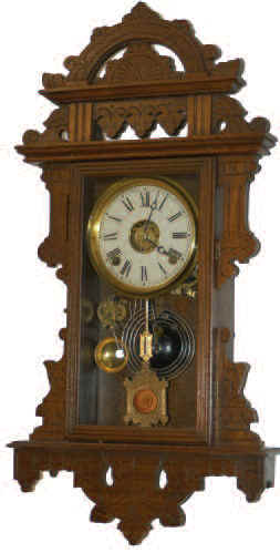 E. N. Welch Mfg. Co. walnut hanging parlor clock, manufactured for the Metropolitan Mfg. Co. possibly to be awarded as prizes or given with the purchase of merchandise. — Antique Clocks Price Guide