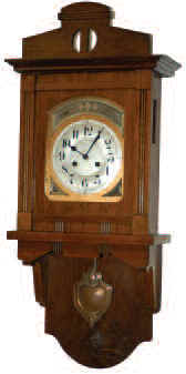 Junghans open swinger clock in a mission style walnut veneered case that is 33.5 inches high, and 14 inches wide. — Antique Clocks Price Guide