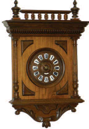 French hanging balcony clock in a 26.5 inches tall walnut case with full turned and fluted columns that have nice turned capitals and bases. — Antique Clocks Price Guide
