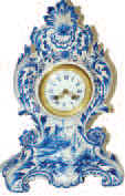 French porcelain clock but case was made in Germany. Blue delft case, 16 inches high, 10.5 inches wide. — Antique Clocks Price Guide