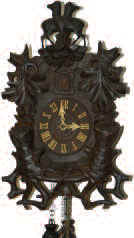 German 30 hour cuckoo in a different looking carved case, 19" high. — Antique Clocks Price Guide