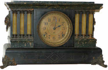 Seth Thomas mantle clock, rare model striking on two cup bells, ca. 1900. The case has an adamantine finish of dark green and black, and is 18 inches wide, 11 inches high. — Antique Clocks Price Guide