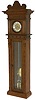 German Vienna (movement) tall clock, in a walnut finished pine double door case. There is considerable carving on all the front surfaces of the case and original headpiece.