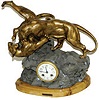 French statue clock featuring two big cats in mortal combat.