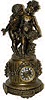 French mantle clock. This is a large metal clock base and with large metal cherub statues.