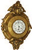Beautiful carved cartel case, housing a clock and barometer that uses the same shaft.