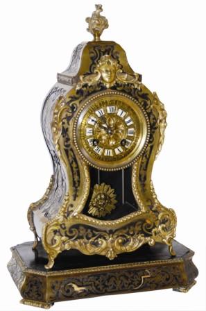French mantle clock, wood case with bronze cast ornaments and inlaid brass all around except for the back. Matching base with the same type inlaid brass all around. — Antique Clocks Price Guide
