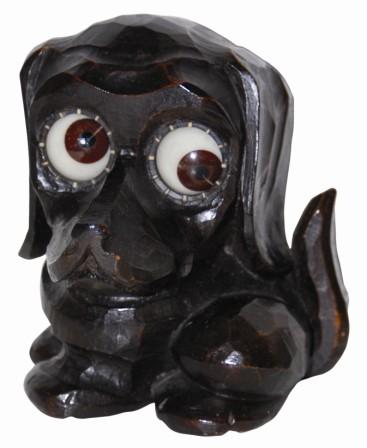German, Oswald, carved composition dachshund, ca 1948. Label underneath, stamped on the back, "Germany", and "ges.gesch". — Antique Clocks Price Guide