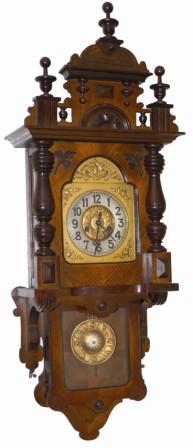 Gustav Becker open well type wall regulator, ca around 1900. It has a spring driven 8 day movement, seat board mounted, and striking a large iron coil gong mounted to the case back. — Antique Clocks Price Guide