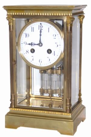 French crystal regulator, not real big but it does have some style. The brass case is not hardly 10.5" high, has four full, fluted columns on the corners, with cast capitals and bases. — Antique Clocks Price Guide