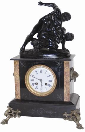French marble clock with statue on top. It would appear the wrestler on top has a pretty tight hold on the other fellows arm. — Antique Clocks Price Guide