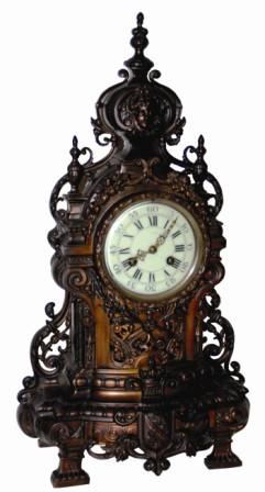 French metal clock, large and has many ornate pieces of castings. The finish is a strange color, black and copper tints. — Antique Clocks Price Guide