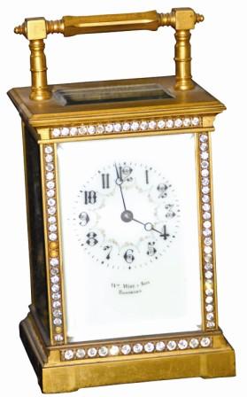French 8 day carriage clock, time and strike, ca 1885. This 7.25" high case is dressed with clear stones around the front edge. — Antique Clocks Price Guide