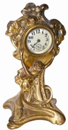 American novelty clock, art nouveau style case featuring a young woman coming into the world via a flower. — Antique Clocks Price Guide