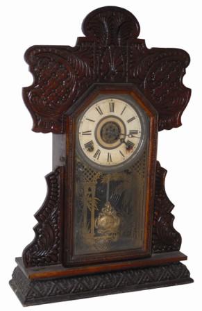 E. Ingraham Clock Co. oak I believe, it is so dark it is difficult to tell. — Antique Clocks Price Guide