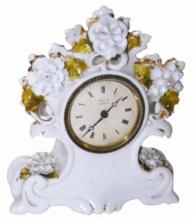 French white porcelain clock with delicate white flowers and some gold highlights. The porcelain petals are very thin and brittle, and for the most part has survived intact. — Antique Clocks Price Guide