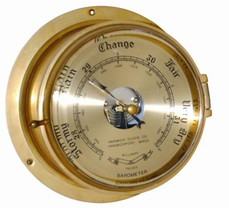 Brass barometer in a large brass case, with a heavily beveled glass over a silver dial. The case is 8" across the back, 6" across the top. — Antique Clocks Price Guide