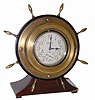 Waltham Watch Co. chronometer. It is displayed in a wood case, ships wheel motif, about 7" tall and 7" wide, brass wheel spokes all intact, and is enclosed in a brass clock case.