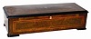 Swiss cylinder music box with a 13" cylinder, it has no broken teeth, a good comb with zither attachment, and double mainspring barrels. It plays eight recognizable tunes including some waltzes and marches.