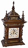 Junghans fancy mantle clock, several pieces of brass ornaments, and a 24" high walnut case that needs some stain/finish, and a few worm holes filled, primarily on the bottom board.