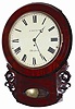 English short drop time only wall clock, certainly a cut above the usual English drop clocks we get. This one is mahogany veneered, 22" high, has some great carved side decorations, round wood bezel, four pegs to hold the top to the box, a bottom hinged door to access the pendulum, a hinged door on the side, and the oval glass at the bottom surrounded by rounded molding.