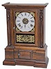 Atkins Clock Company, their common ca 1863 "London" model. Rosewood veneered case is 16.5" high, has plain half columns, and gold foil tablets.