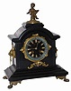 French black marble clock with metal ornamentation, from feet underneath to the small cupid on the top. No ornamental pieces are missing.