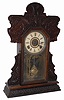 E. Ingraham Clock Co. oak I believe, it is so dark it is difficult to tell.