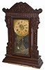 Wm. L. Gilbert Clock Co. oak kitchen clock, "Pattern No. 11 - Jewel Sets", ca 1910.