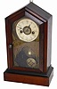 Cottage clock, possibly German. There is a black label on the base but I cannot read it, and the backboard, inside, is covered with oil cloth paper.