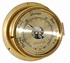 Brass barometer in a large brass case, with a heavily beveled glass over a silver dial. The case is 8" across the back, 6" across the top.