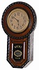 Japanese short drop clock, very ornately decorated with rope carved moldings around the front edges. The case is 18.5" high, probably made with an evergreen type wood, probably pine, stained dark.