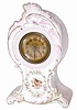 Miniature china clock, I would think it was kiln fired overseas as most all were. Principal colors are pinks, white, gold, and painted flowers on the front and sides.