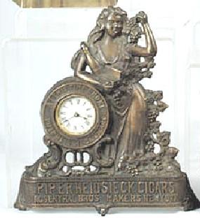 A Piper Heidsieck Cigars figural advertising clock. — Antique Clocks Price Guide