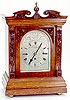 CARVED OAK BRACKET CLOCK, English, c.1900;